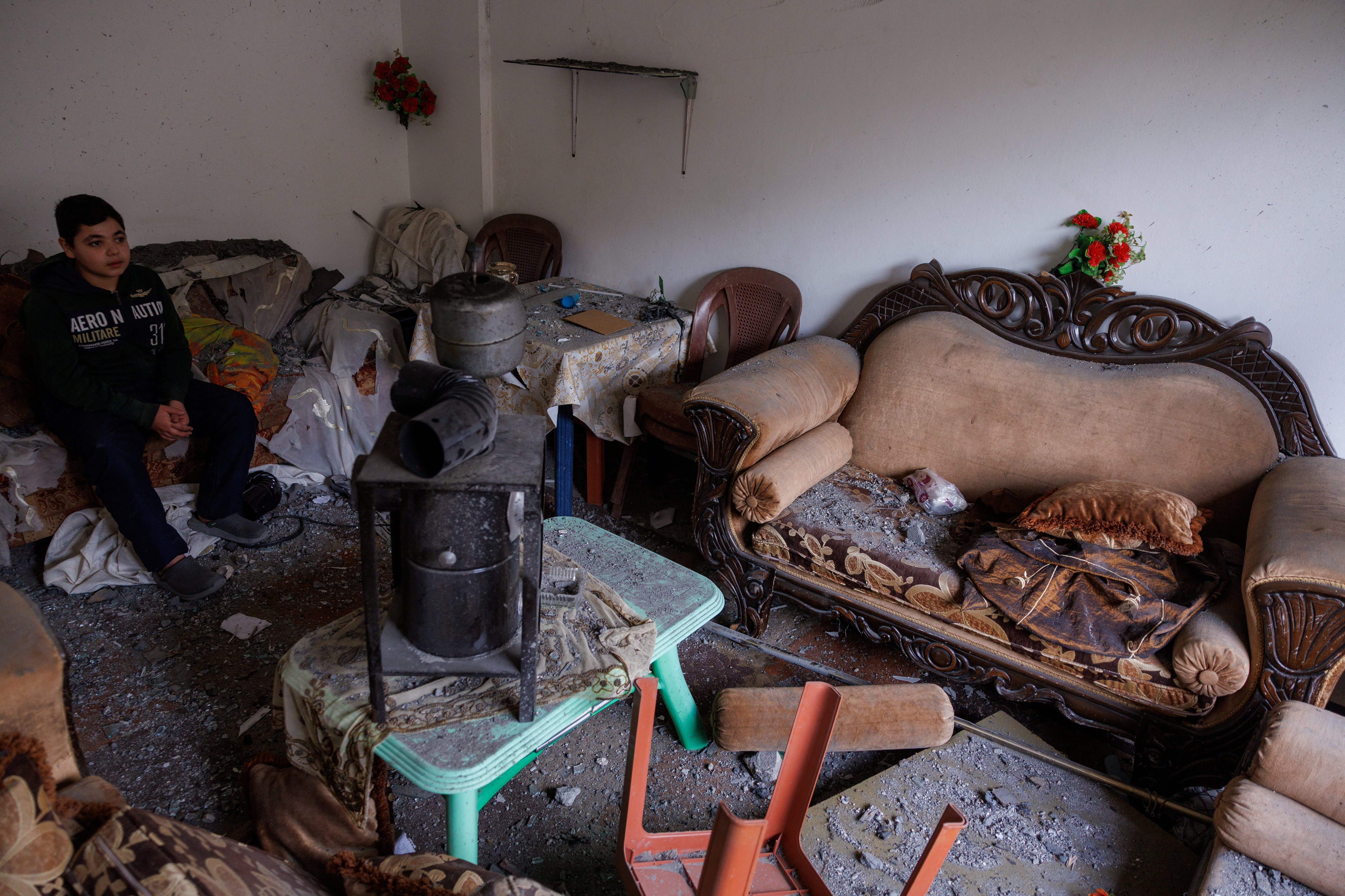Sajed Dahnoun, 12, who said he survived an Israeli strike that forced him to flee with his parents to Beirut, sits in his neighbours' sitting room in Nabatieh on 18 April, since the ceasefire