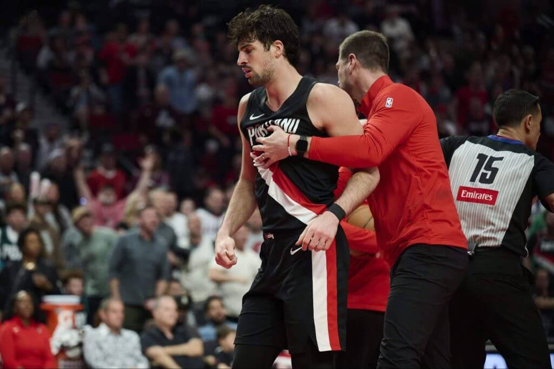 Portland Trail Blazers assistant coach Tiago Splitter pulls forward Deni Avdija away from San Antonio Spurs guard Stephon Castle (not pictured).