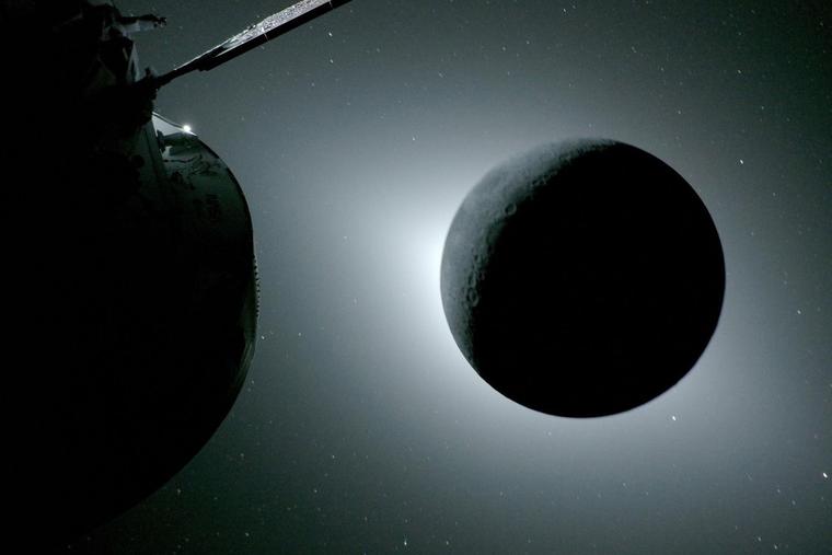 The moon, backlit by the Sun, is seen on April 6 from a camera mounted on the Orion spacecraft’s solar array wing, with part of Orion visible at left. Earthlight faintly illuminates the Moon’s left edge, making it slightly brighter than the rest of the disk.