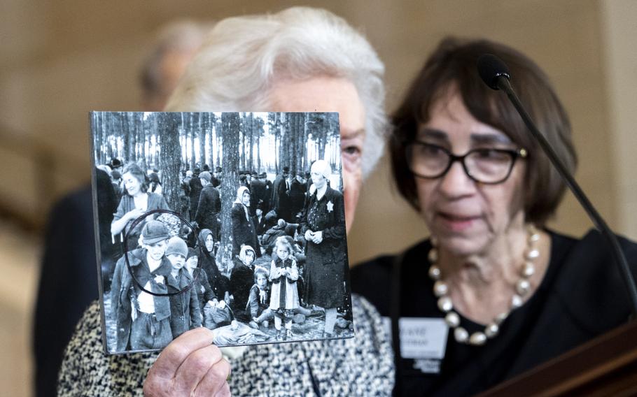 Weiss holds up a photo.