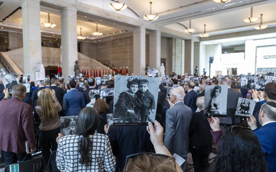 Members of the audience show their photos.