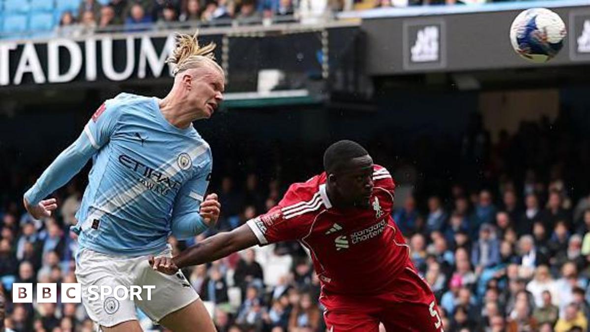 Erling Haaland, wearing Manchester City's light blue kit, celebrates his latest hat-trick by making a three-finger salute with his left hand