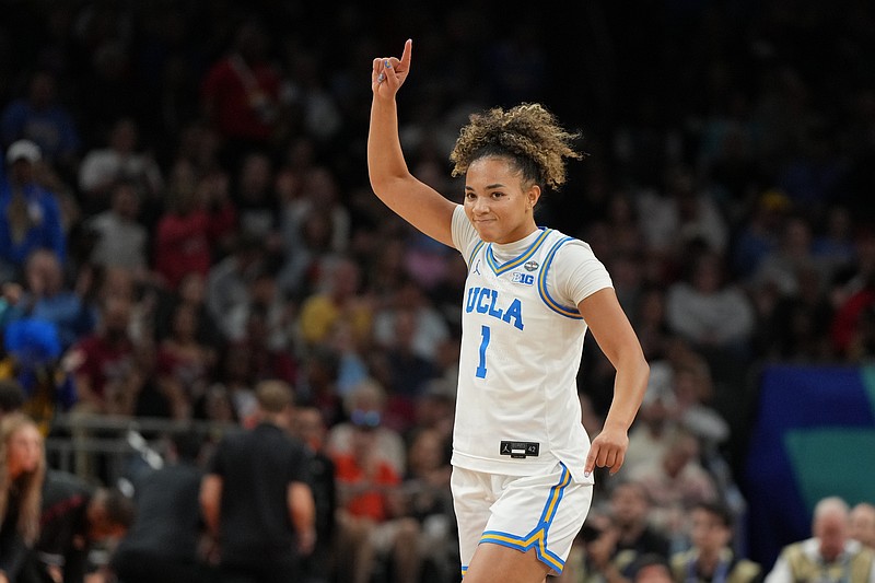 UCLA guard Kiki Rice (1) celebrates after a play against South Carolina during the second half of the women's National Championship Final Four NCAA college basketball tournament game, Sunday, April 5, 2026, in Phoenix. (AP Photo/Rick Scuteri)
