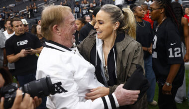 Aces coach Becky Hammon greets Raiders and Aces owner Mark Davis before the start of an NFL gam ...