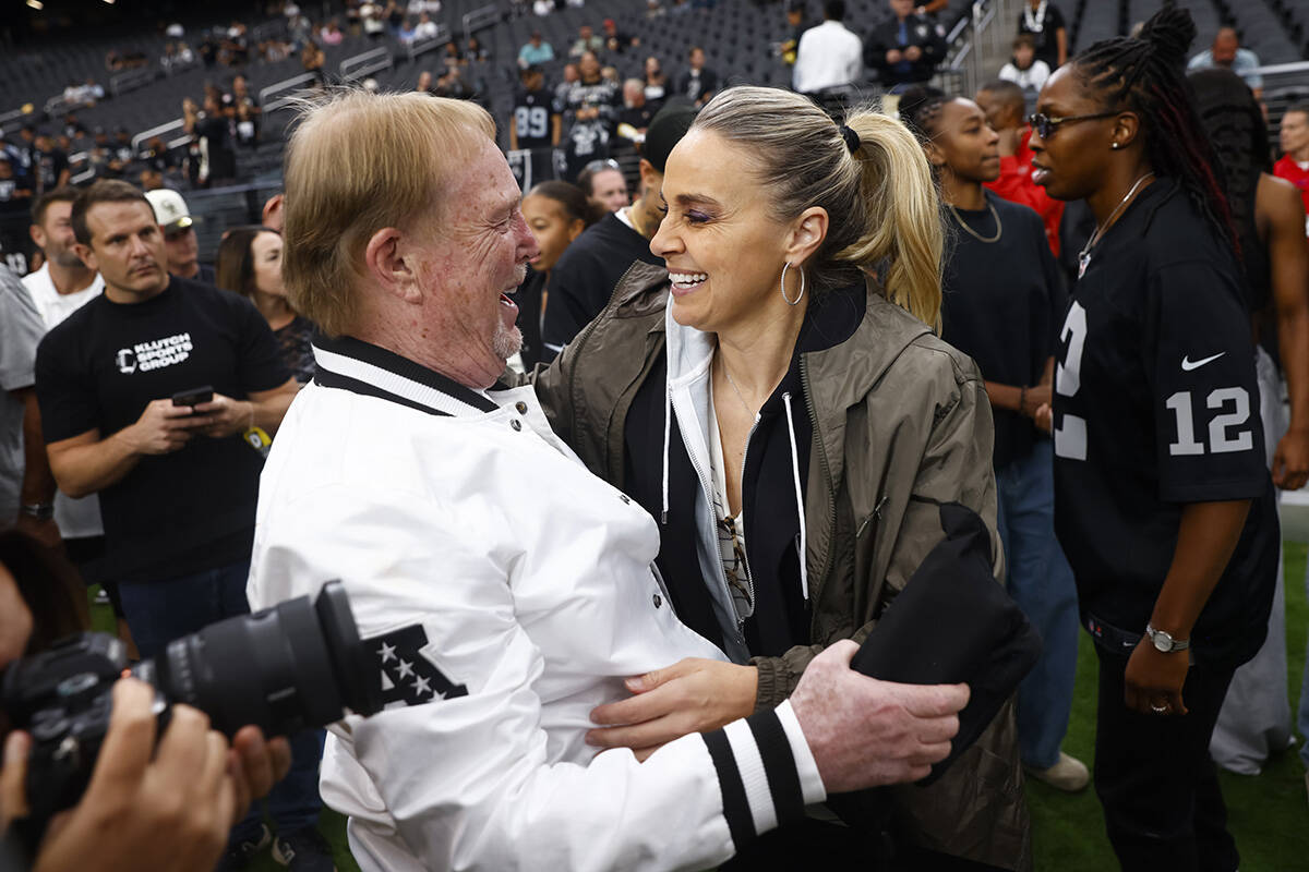 Aces coach Becky Hammon greets Raiders and Aces owner Mark Davis before the start of an NFL gam ...