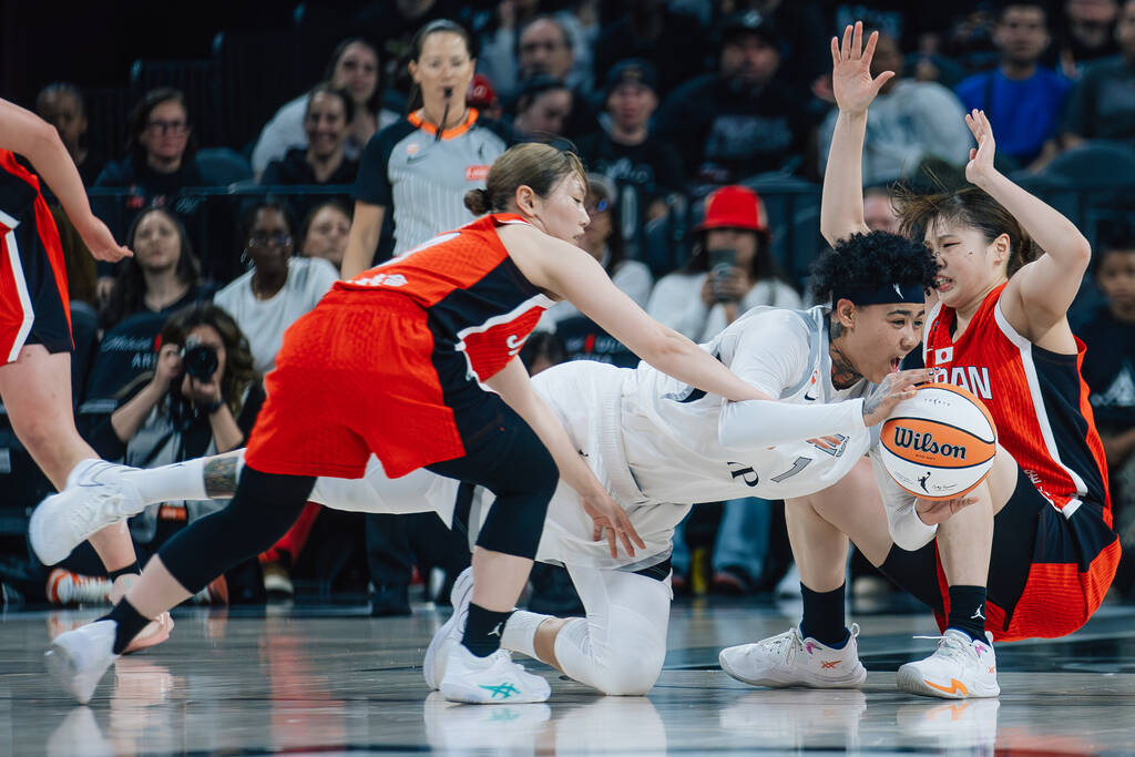 Aces forward Kierstan Bell (1) is tripped while handling the ball in a preseason WNBA basketbal ...