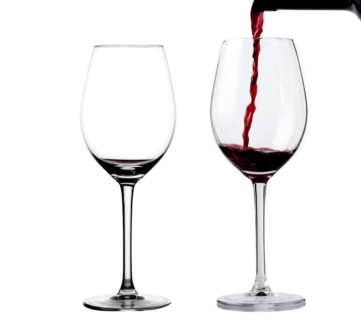 filling two glasses of red wine on a white background