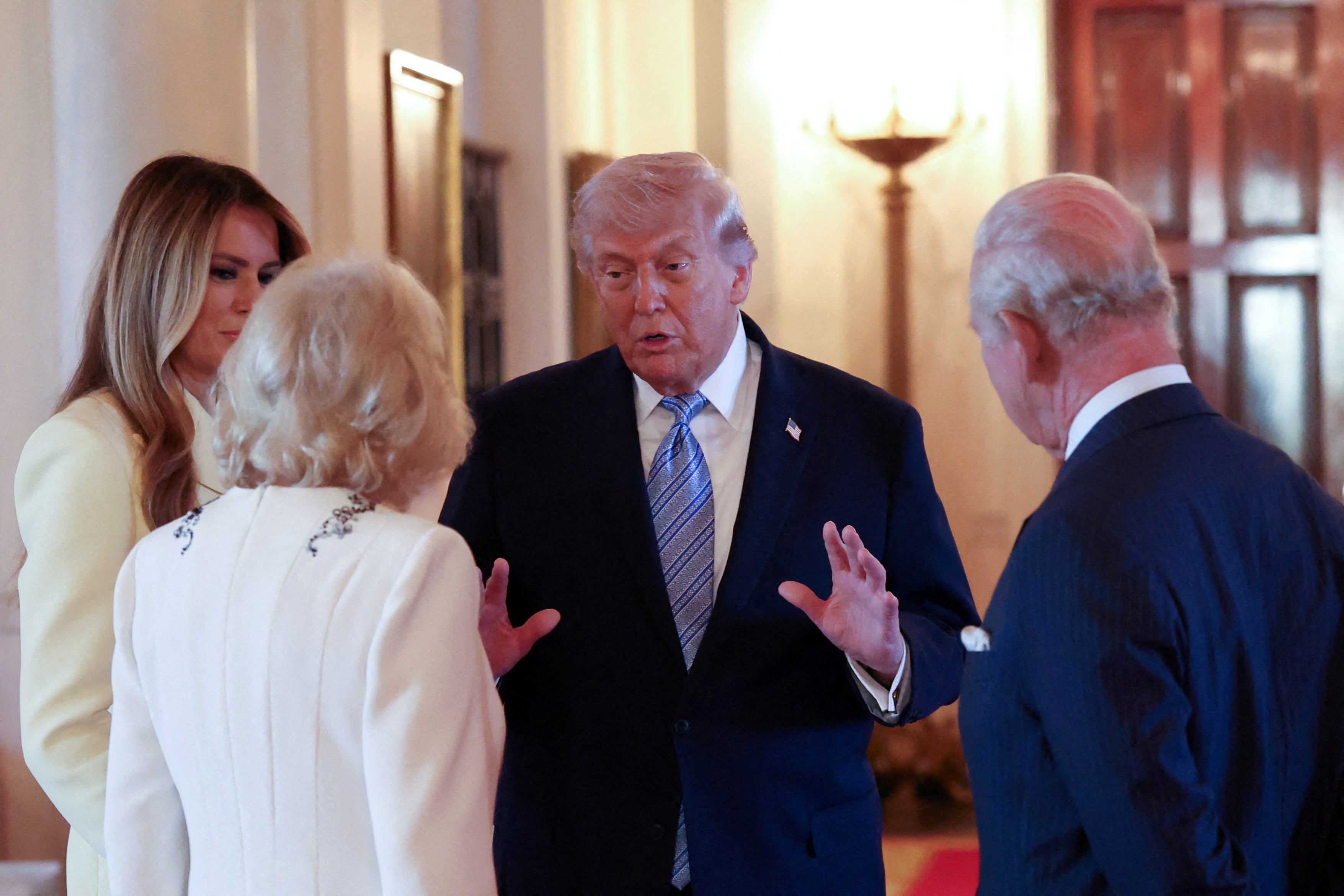 Queen Camilla (C/L), King Charles III (R) and US First Lady Melania Trump (L) listen to US President Donald Trump on Monday