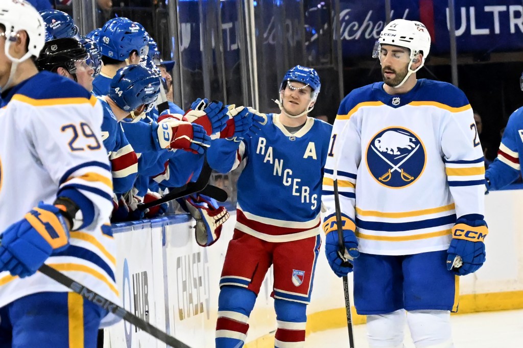 Rangers defenseman Adam Fox (23) celebrates his goal with his teammates as he comes along the bench in the second period of the Buffalo Sabres and Rangers game at MSG.