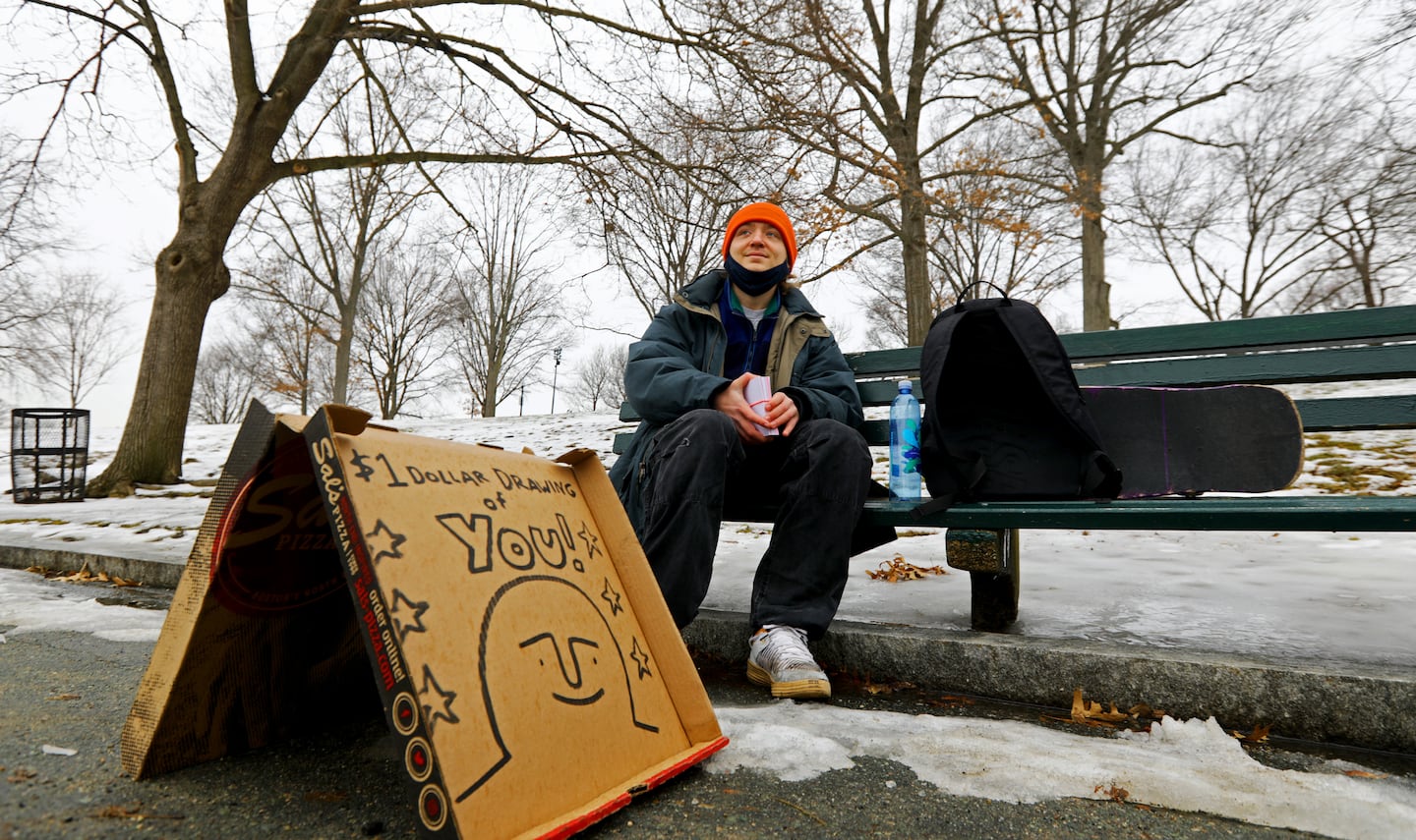 Artist Nick Shea sets up shop on a bench on the Boston Common on Feb. 7, 2022.