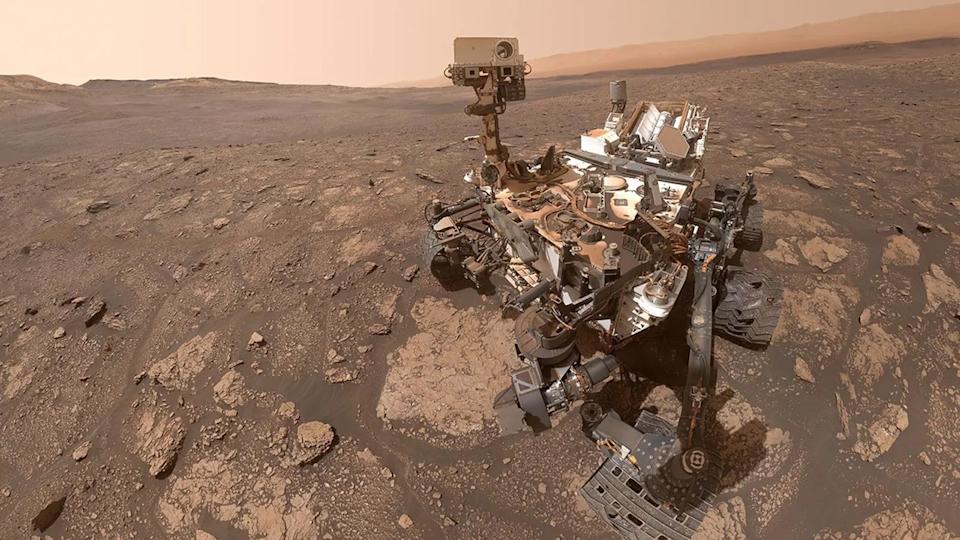 A "selfie" taken by the Curiosity rover on Mars. The rover sits on the reddish-brown, rocky surface.