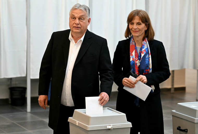 Hungary's Prime Minister Viktor Orban of the Fidesz party stands next to his wife, Aniko Levai, as he casts his ballot at a polling station in Budapest during a general election on Sunday.
