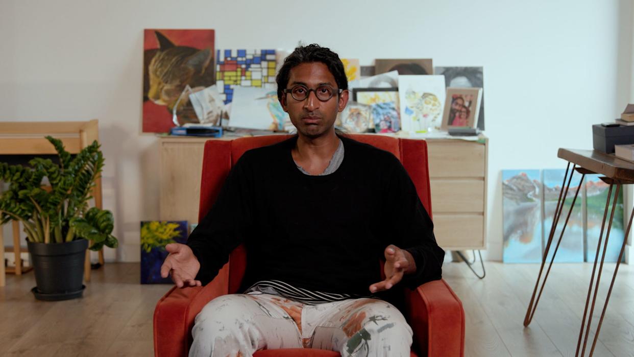 Ramana Kumar sitting in a red chair with a black long sleeved shirt.