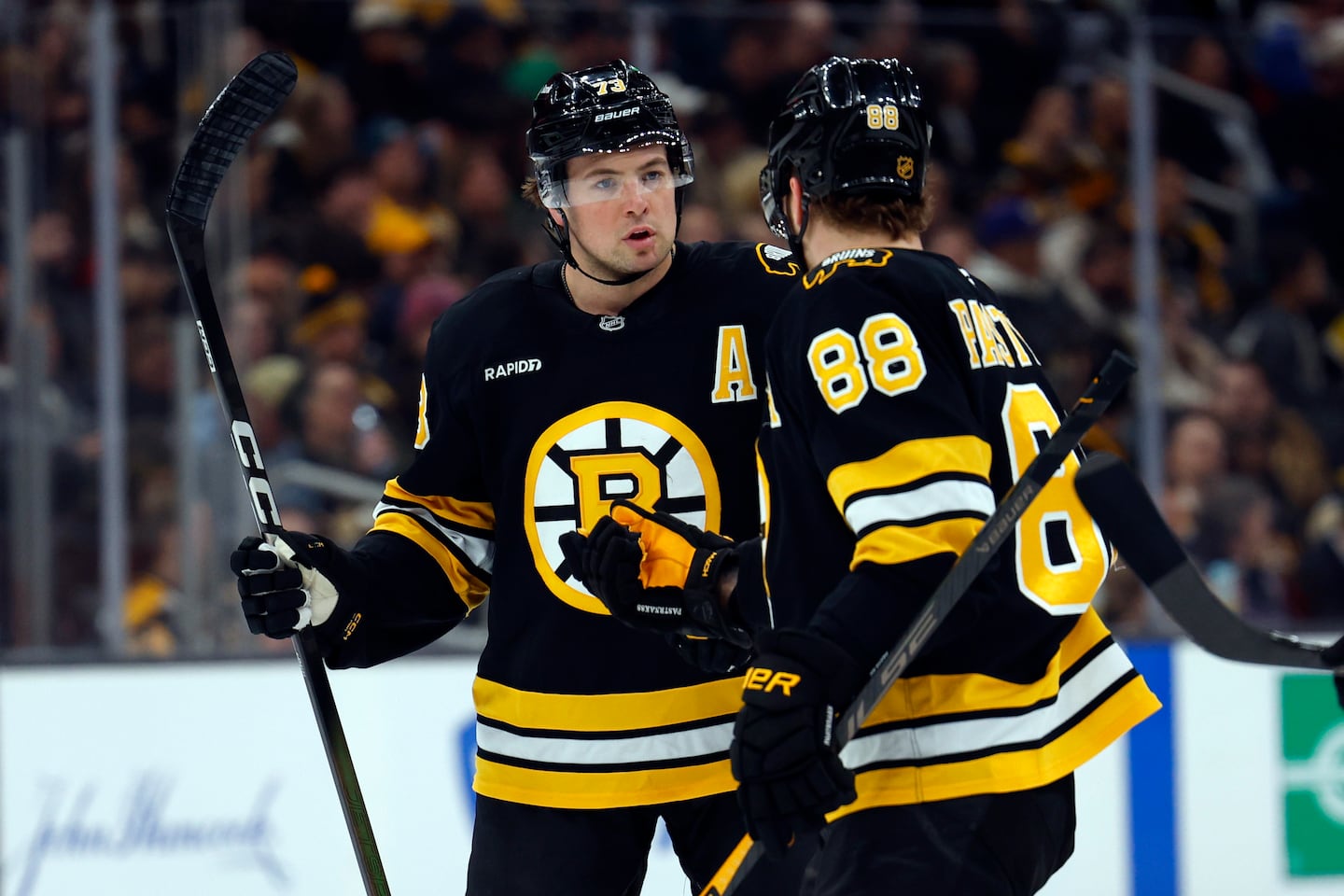Charlie McAvoy (left) is no offensive David Pastrnak, but he does lead Bruins defenseman with 11 goals and 47 assists.