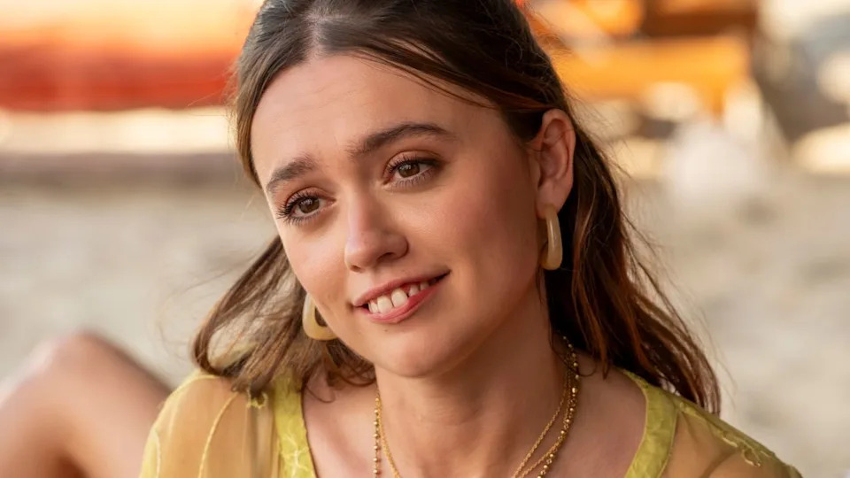  Aimee Lou Wood tilts her head slightly as she smiles on a beach in The White Lotus S3 E8 - "Amor Fati.". 