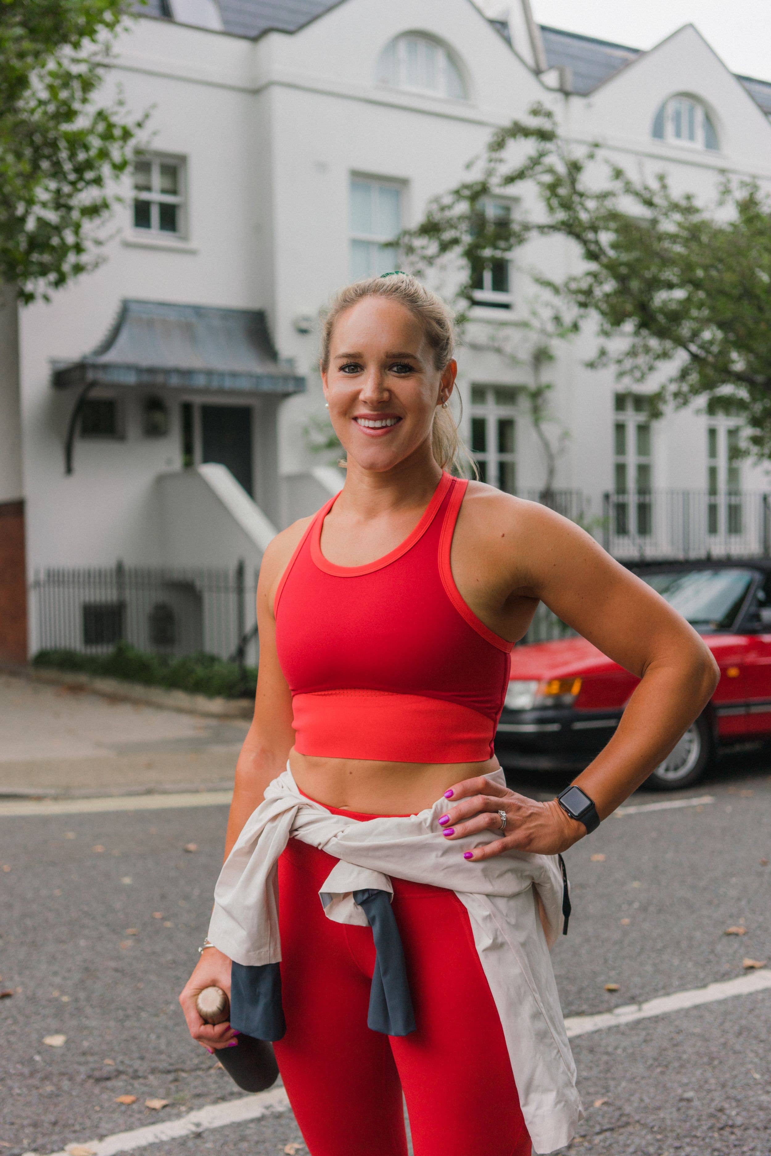 personal trainer sarah Campus in red activewear smiling 