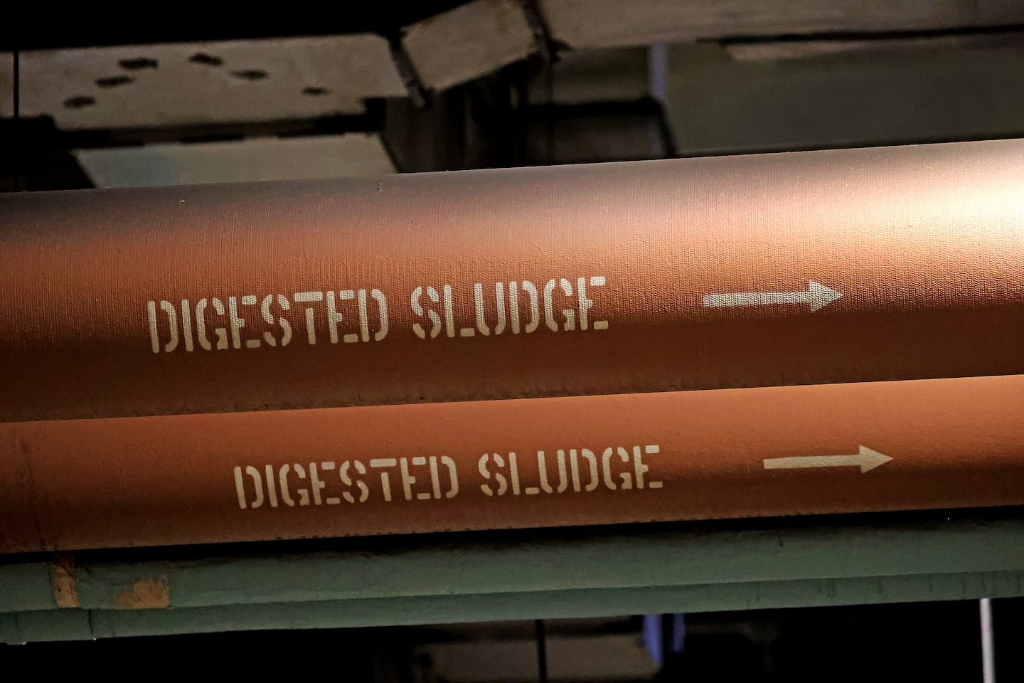 An electric vehicle in the bowels of Deer Island, above, and well-labeled pipes, below.