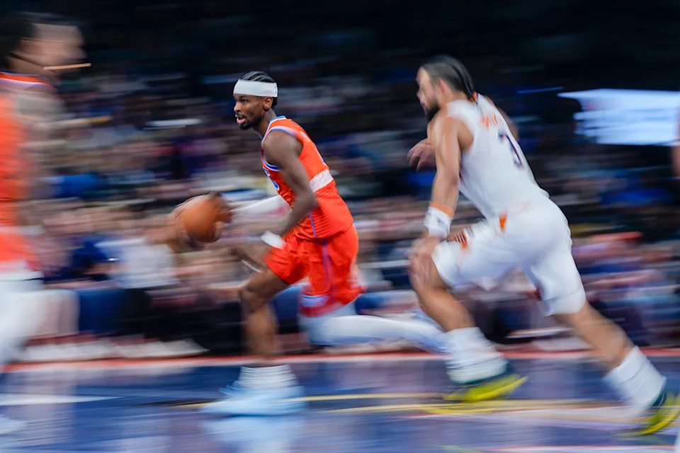 Oklahoma City Thunder guard Shai Gilgeous-Alexander (2) dribbles past Phoenix Suns forward Dillon Brooks (3) during an NBA Cup basketball game between the Oklahoma City Thunder and the Phoenix Suns at Paycom Center in Oklahoma City, Friday, Nov. 28, 2025. The Thunder won 123-119.