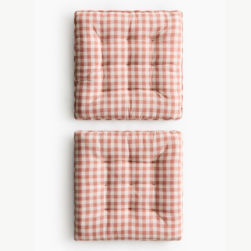 two pink gingham seat cushions