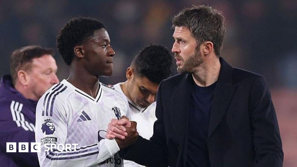Manchester United head coach Michael Carrick (right) shakes hands with Kobbie Mainoo
