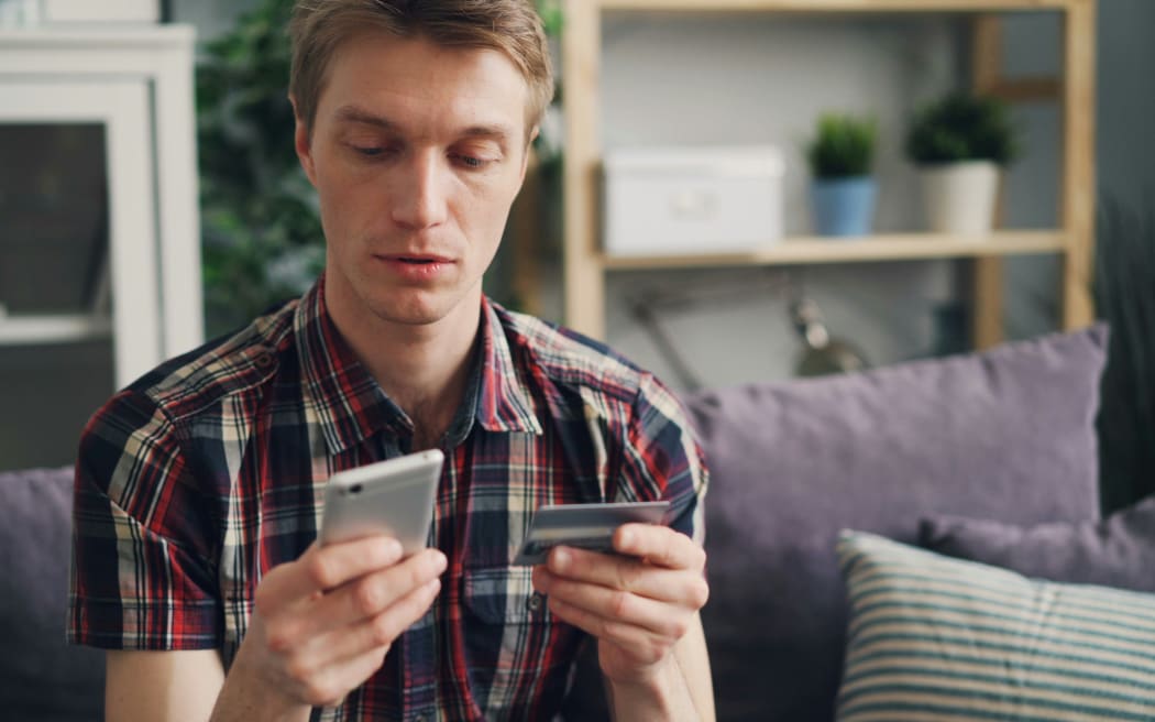 A man shops online from his phone.