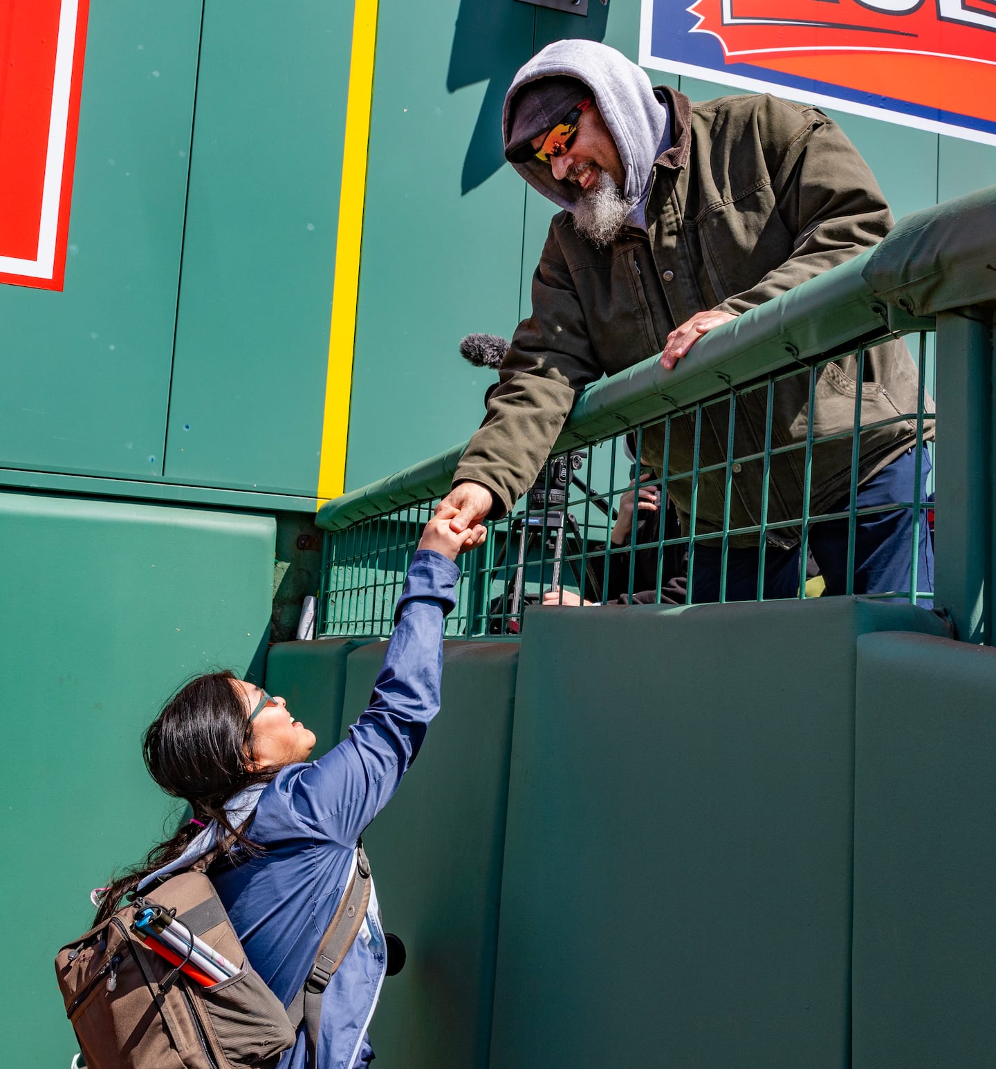 Caruso greets Joe LeMar, her Achilles International adaptive running coach who calls her "an inspiring, shining light." She recently, tethered to a guide, completed a Boston Athletic Association 5K run.