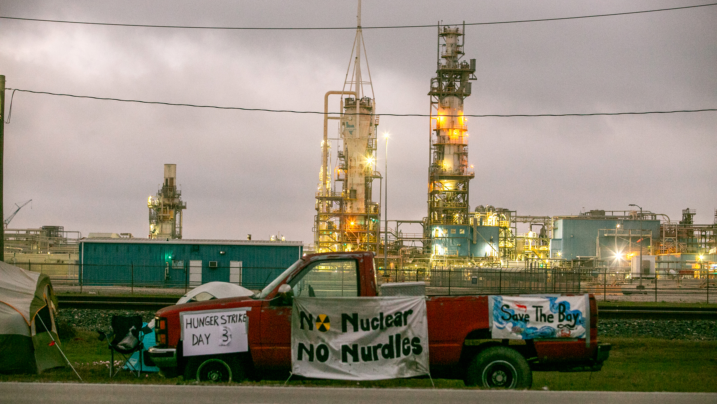 Trains screech and rumble while cooling towers roar behind Diane Wilson’s campsite off State Highway 185 in Seadrift at twilight on March 5.