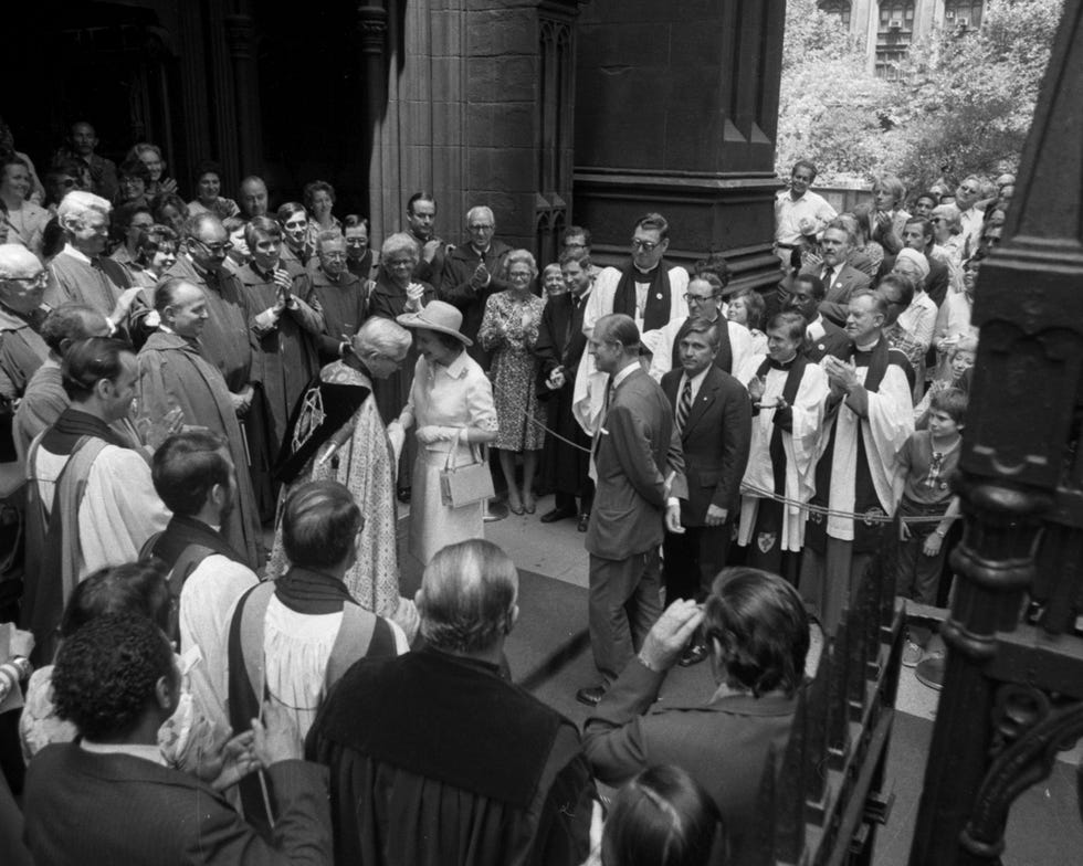 The Rev. Robert Parks, rector of Trinity Church, greets Quee