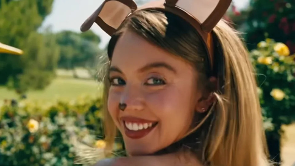 A close up of Sydney Sweeney wearing dog ears and smiling in Euphoria.