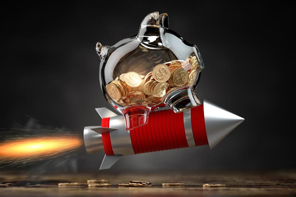 A piggy bank is hitching a ride on a rocket. 