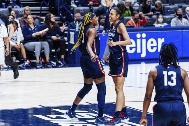 UConn's Aaliyah Edwards, left, and Olivia Nelson-Ododa celebrate during the first half of the Huskies win at Xavier in Cincinnati on Friday night, Feb. 18, 2022