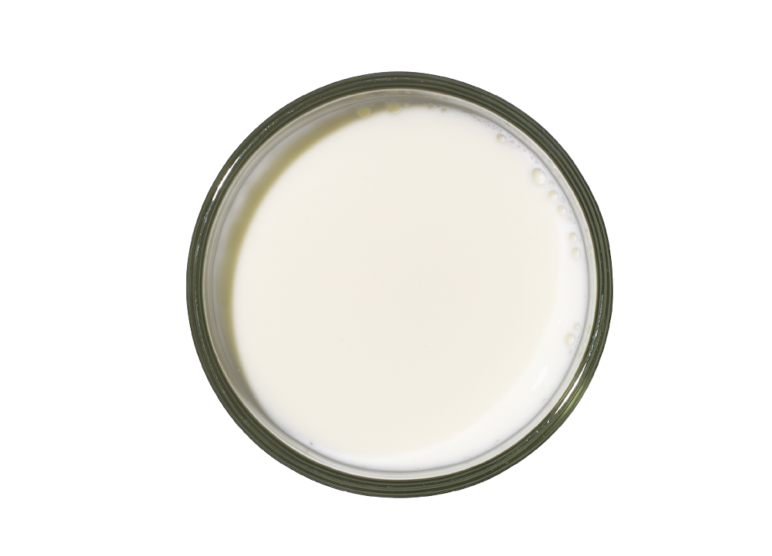 a round glass container filled with white liquid a round glass container filled with white liquid