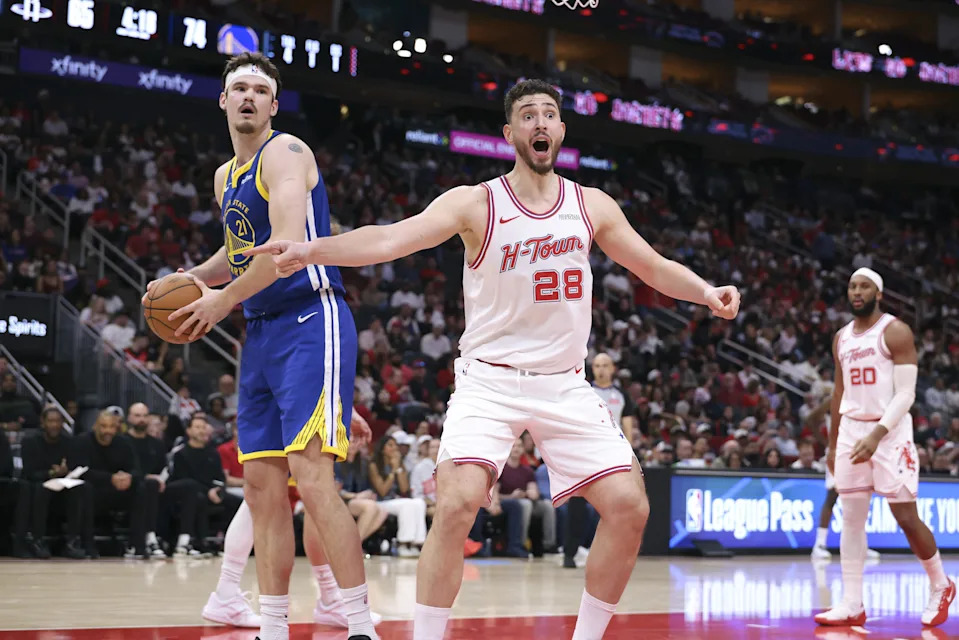 Mar 5, 2026; Houston, Texas, USA; Houston Rockets center Alperen Sengun (28) and Golden State Warriors center Quinten Post (21) react after a play during the third quarter at Toyota Center. Mandatory Credit: Troy Taormina-Imagn Images