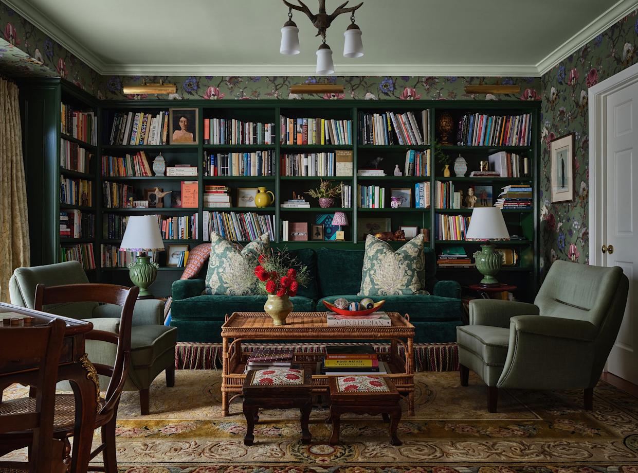Cozy living room with a bookshelf and green sofa.