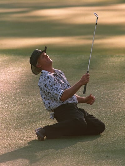 Greg Norman falls to the ground after narrowly missing his chip shot on the 15th green. Photograph: Stephen Munday/Allsport