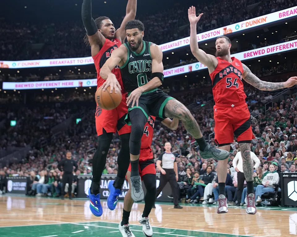 Apr 5, 2026; Boston, Massachusetts, USA; Boston Celtics forward Jayson Tatum (0) passes the ball back against Toronto Raptors forward Collin Murray-Boyles (12) during the first half at TD Garden. Mandatory Credit: Gregory Fisher-Imagn Images