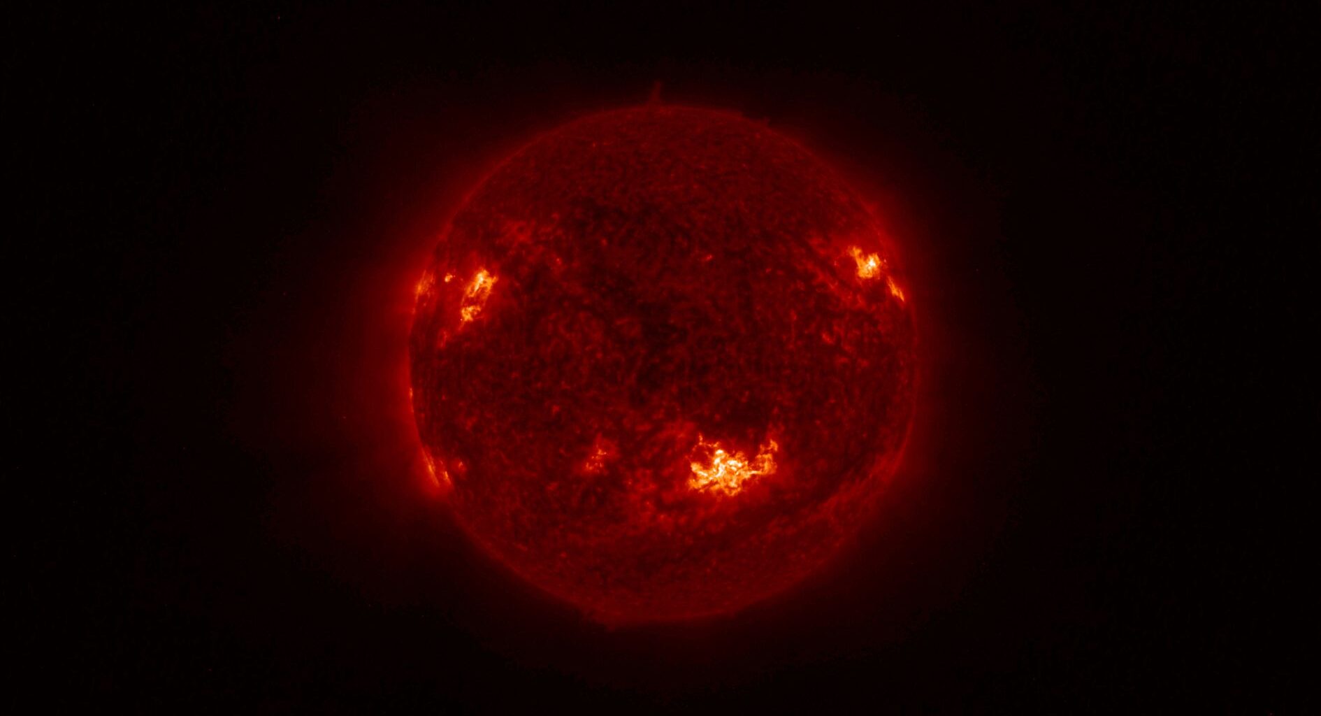 A fiery red ball against a black background.