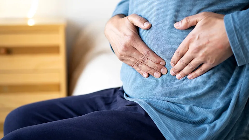 Man holding stomach in pain