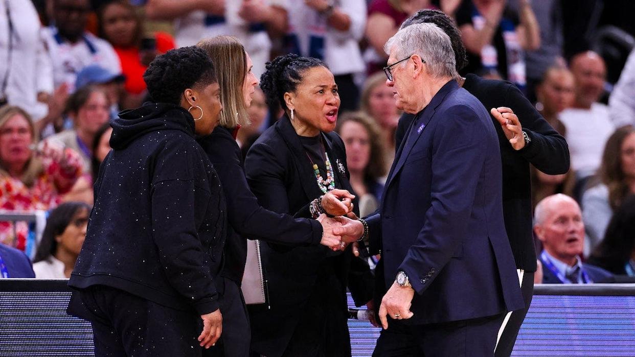 Dawn Staley arguing with Geno Auriemma during a basketball game in Phoenix, Arizona