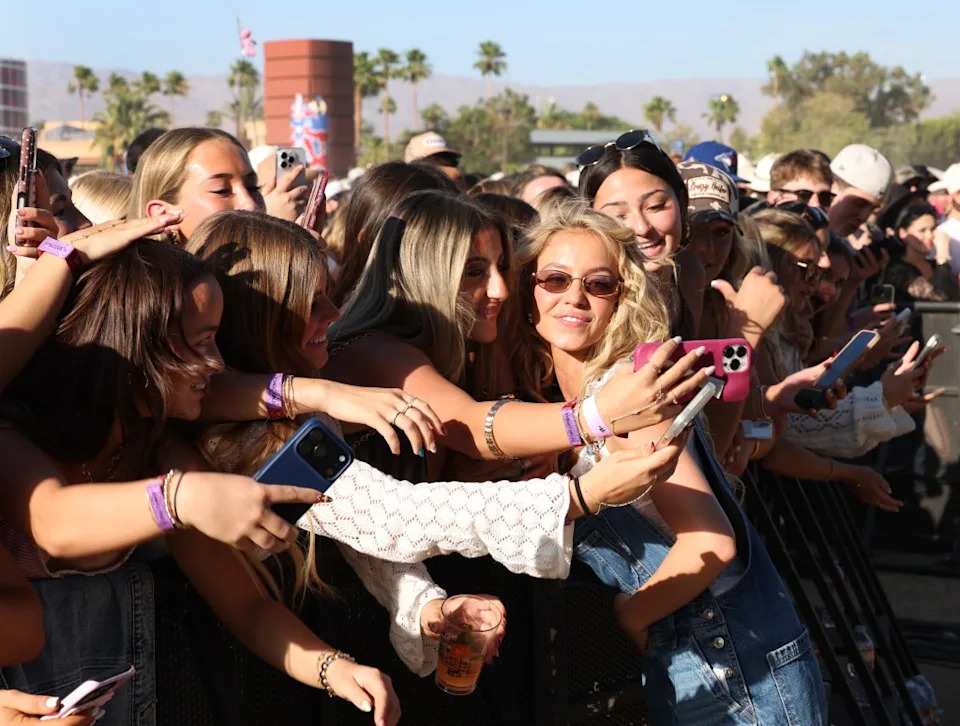 Sydney Sweeney takes photos with fans before watching rapper BigXthaPlug perform on the Mustang Stage during the Stagecoach Country Music Festival on April 24, 2026. Los Angeles Times via Getty Images
