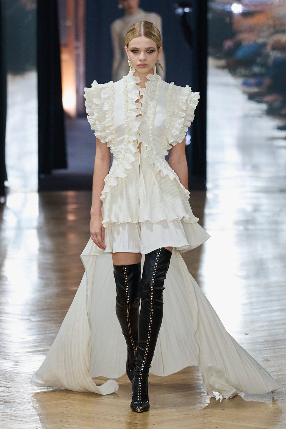 Runway model showcasing a modern, designer outfit