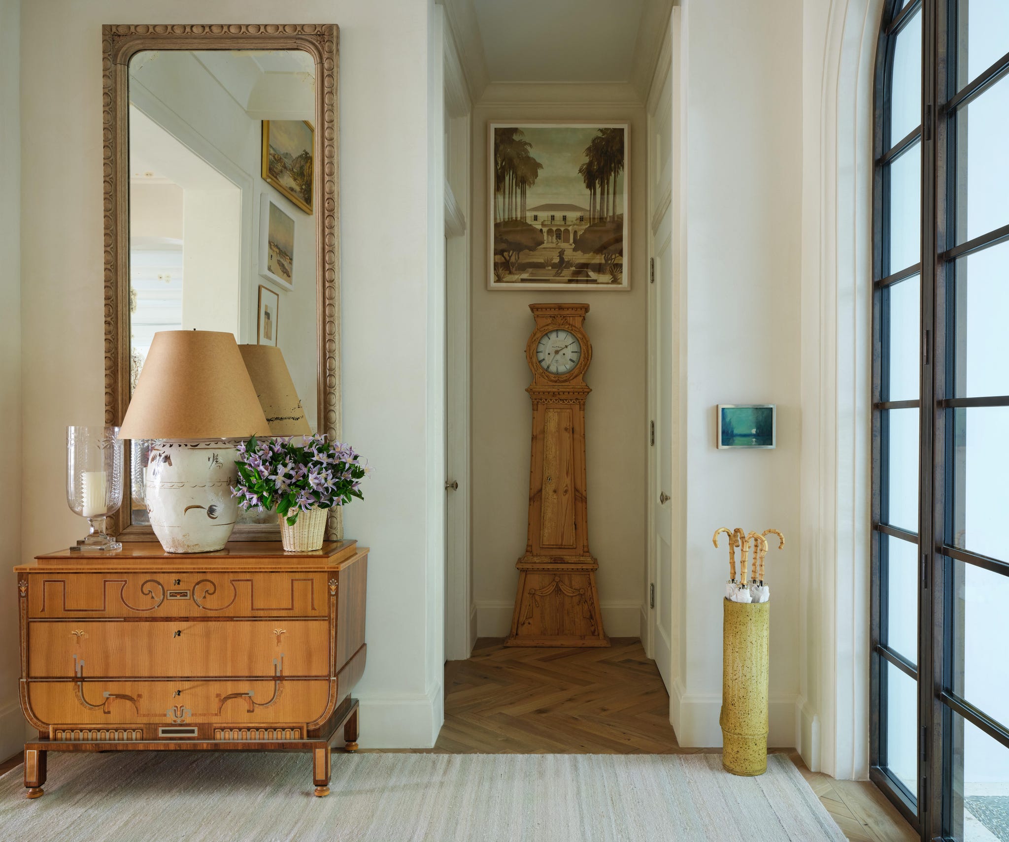 A stylish foyer featuring a console table and a clock