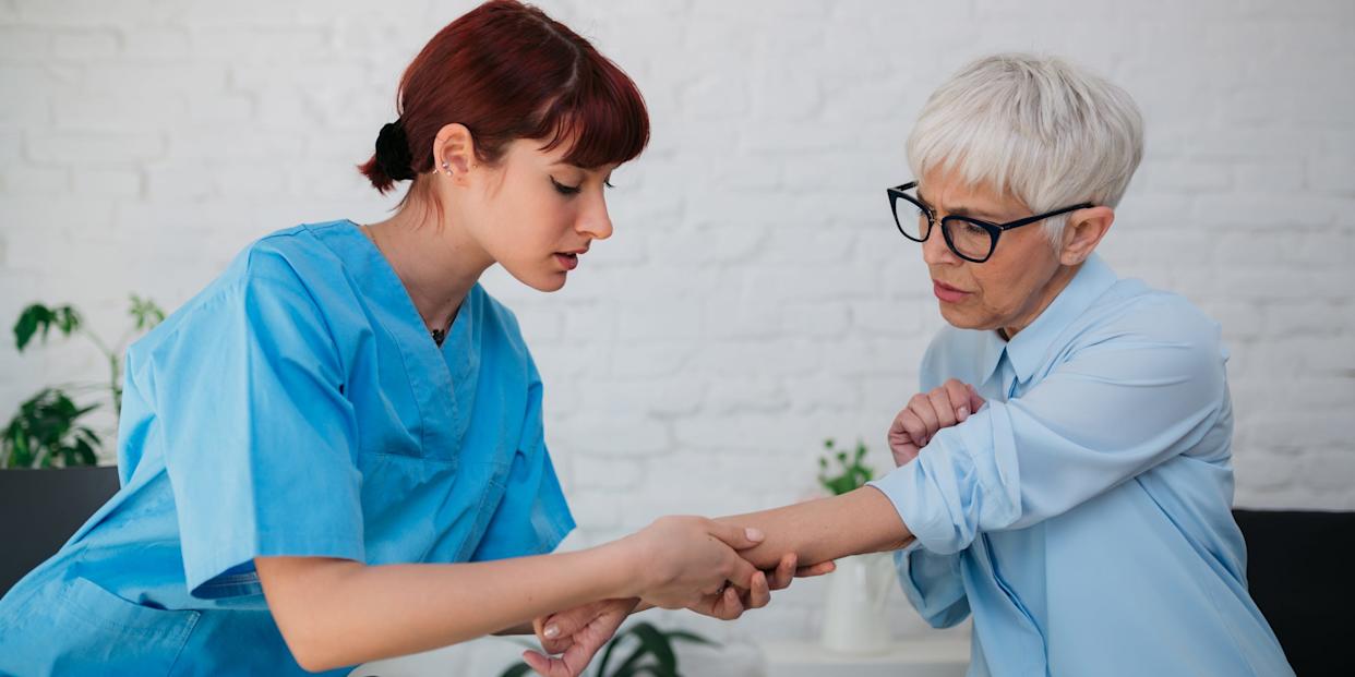 Female medical professional examining a senior patient