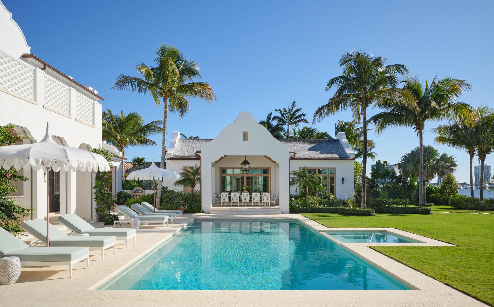 Pool area with cabana behind it