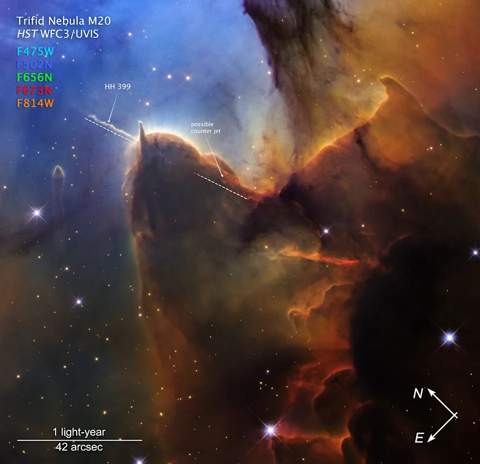 Swirling clouds of brown gas and dust mix against a dark blue starry background.