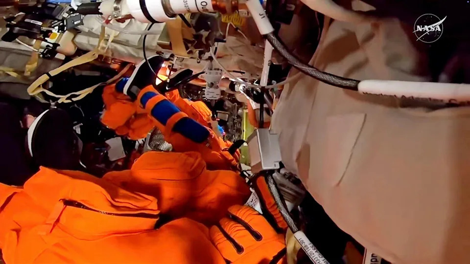 The astronauts donned their pressure suits Sunday to demonstrate how long it would take to put them on in an emergency in the cramped confines of their Orion capsule. The test also served as a rehearsal of sorts for re-entry day when the astronauts will suit back up for their return to Earth. / Credit: NASA