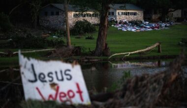 Camper's belongings sit outside one of Camp Mystic's cabins near the Guadalupe River after a flash flood swept through the area Monday, July 7, 2025, in Hunt, Texas. (AP Photo/Eli Hartman)
