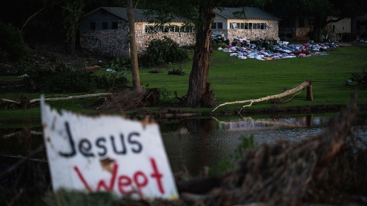 Camper's belongings sit outside one of Camp Mystic's cabins near the Guadalupe River after a flash flood swept through the area Monday, July 7, 2025, in Hunt, Texas. (AP Photo/Eli Hartman)