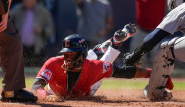 Cleveland Guardians' Angel Martínez scores on a single hit by Gabriel Arias as Detroit Tigers catcher Dillon Dingler, right, reaches with the tag during the fourth inning of Game 1 of the American League Wild Card baseball playoff series in Cleveland, Tuesday, Sept. 30, 2025.