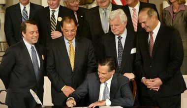 Governor Mitt Romney signed the health care bill as political leaders looked on in 2006.